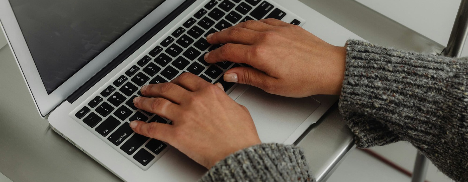 A person typing on a laptop.